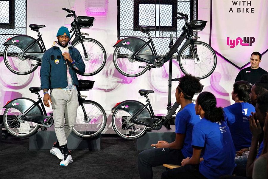 Lebron James speaking on stage in-front of Lyft share bikes