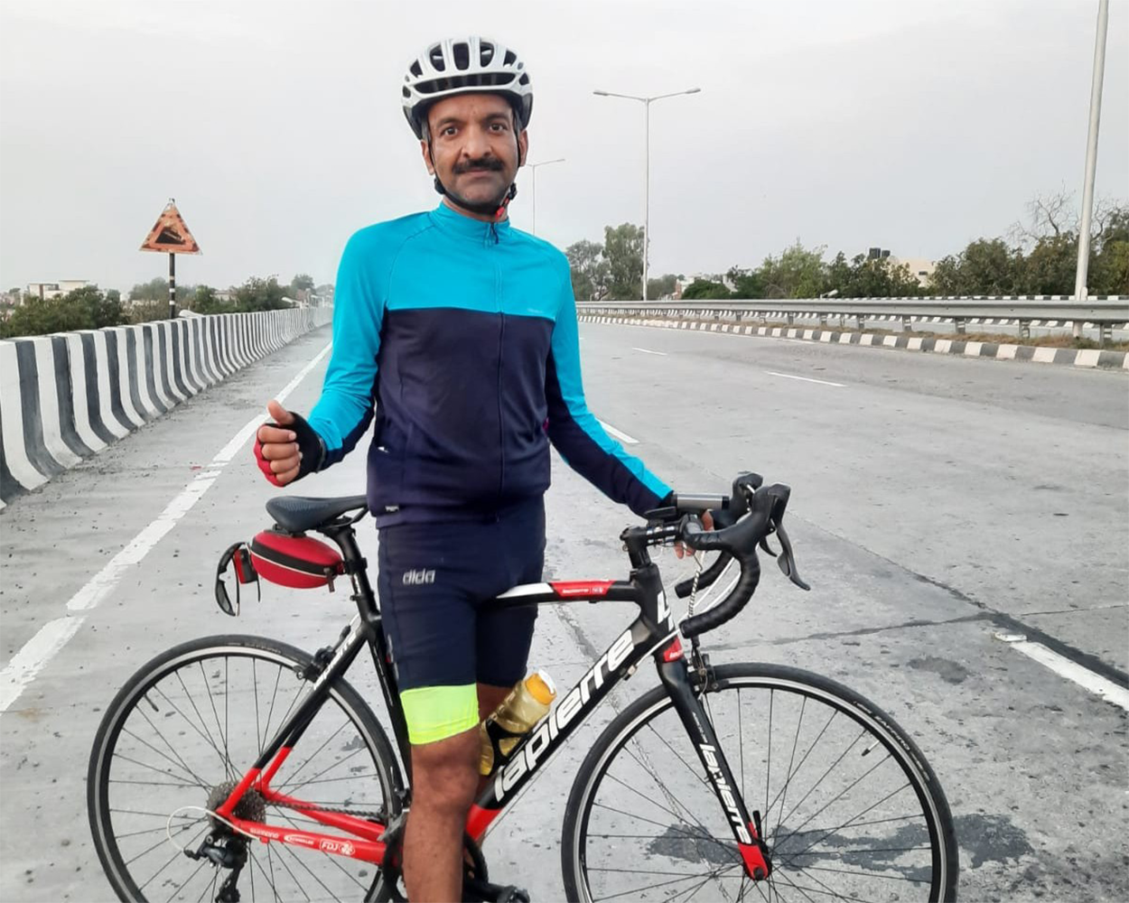 Vikas Goyal with his bike on a road